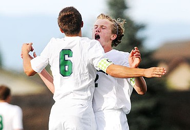 <p>Colton Becker, 6, is celebrates with Ben Wright after Becker scored in the opening minutes against Missoula Sentinel at Glacier on Tuesday. (Aaric Bryan/Daily Inter Lake)</p>