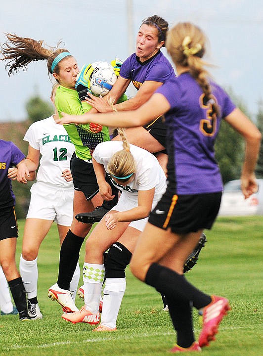 <p>Glacier goalie Amy Braig is crashed into as she makes a save on a corner kick against Missoula Sentinel on Tuesday. (Aaric Bryan/Daily Inter Lake)</p>