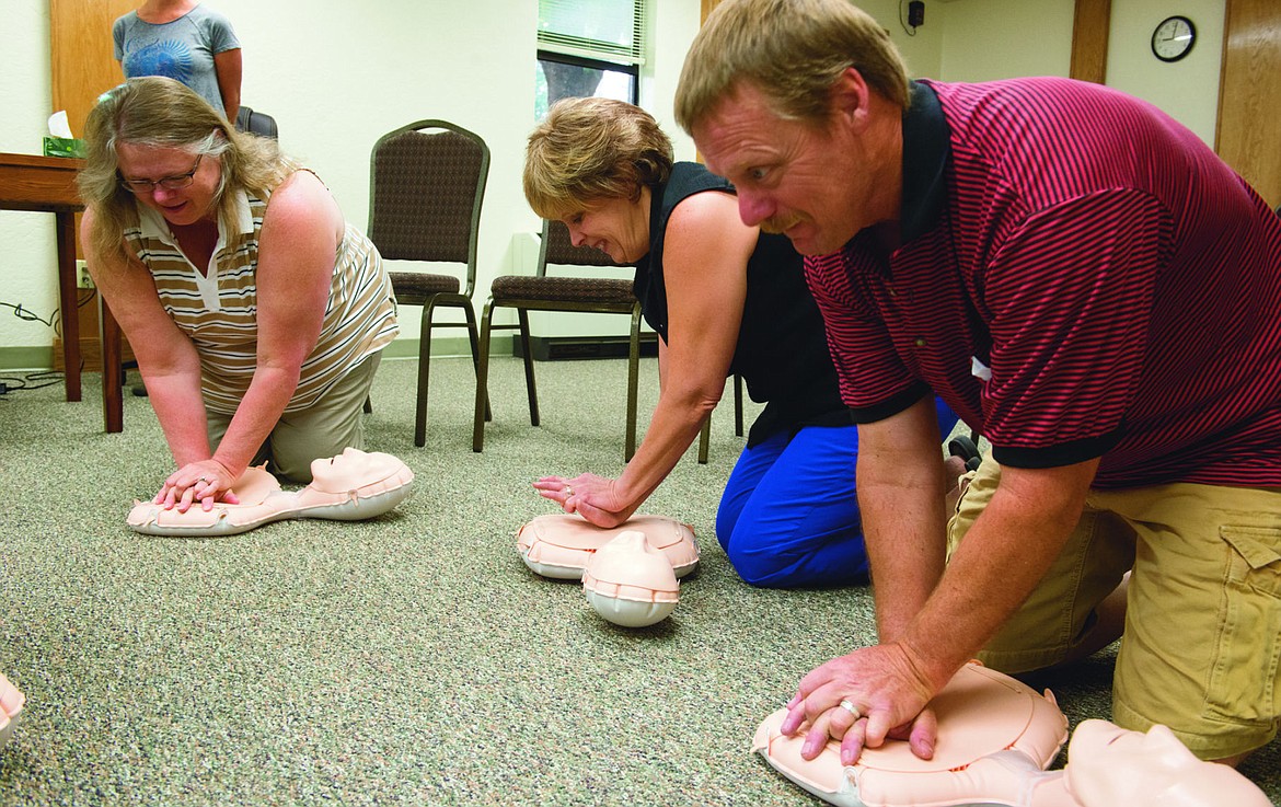 &lt;p&gt;From left to right, Bobbie Christensen, Lisa Wadsworth and Les Lantz practice chest compressions.&lt;/p&gt;