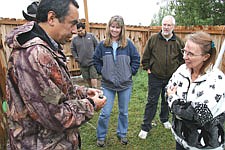 Carlos Rodriguez shows off a golden eagle pellet to Elaine Williamson and Bill and Lois Frauen during last Saturday's second annual Pet Fair at the South Shore Vet Clinic in Polson.