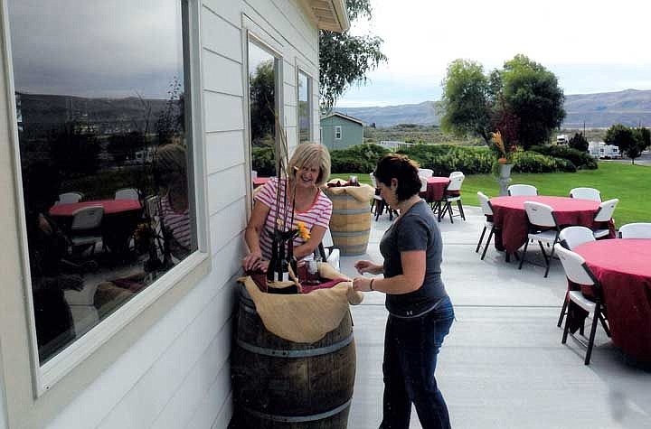 Cathy Potter and Tiffany Workinger put final touches on the outside d&eacute;cor for last year's Sip of the Slope.