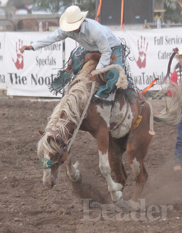 &lt;p&gt;Alan Kole Gobert of East Glacier hangs onto a saddle.&lt;/p&gt;