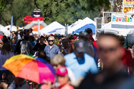 &lt;p&gt;Larry Walker navigates his way through the crowds and vendors' booths along Lake Coeur d'Alene Drive during the Diamond Cup.&lt;/p&gt;
