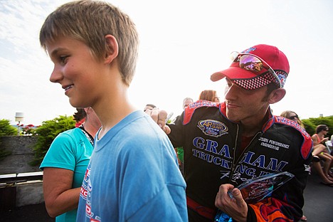 &lt;p&gt;Jimmy Shane, driver of the Graham Trucking H1 Unlimited hydroplane, signs the back of a t-shirt worn by Luke Simisky, 12, of Coeur d'Alene, Sunday after winning the 2013 Coeur d'Alene Diamond Cup.&lt;/p&gt;
