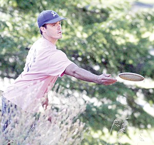 <p>Libby's Richard Brumbaugh takes his second shot on No. 1, a par 3, during the Montana Disc Golf State Championships Saturday at Libby Dam.</p>