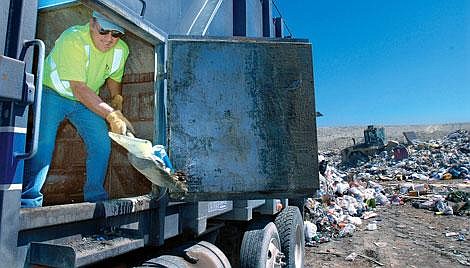 For 27 years, Steve Sakaske has been hauling trash for Evergreen Disposal. On Wednesday, Sakaske shoveled out the last bits of debris from his truck at the Flathead County Landfill. &#147;Business is always picking up,&#148; he said. He represents one of an army of people laboring to keep life tidy in the Flathead. Karen Nichols/Daily Inter Lake