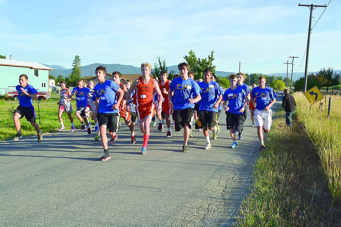 &lt;p&gt;Runners from the Plains, Thompson Falls and Arlee Cross Country teams run down River Road East in Plains.&lt;/p&gt;