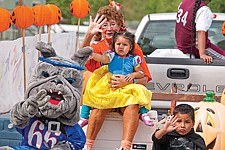 The McClure kids including Wacey, dressed as the Mission Bulldog, Kellen as Batman, and Brooklyn as Snow White, ride along with Margine Asay on the SOAR program's float.