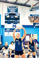 Junior setter Loren Erickson pushes the ball to the outside hitter last weekend at Mission's home tournament.