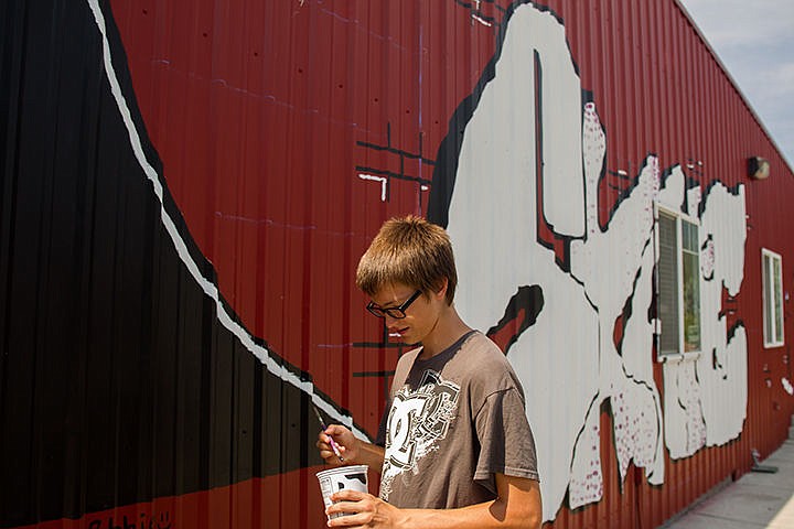 &lt;p&gt;MIKE CURRY/Press&lt;/p&gt;&lt;p&gt;Robbe O&#146;Neill,15, dips his brush in a container of paint while signing his skatepark-themed artwork on the side of the City of Rathdrum Parks and Recreation building Friday.&lt;/p&gt;