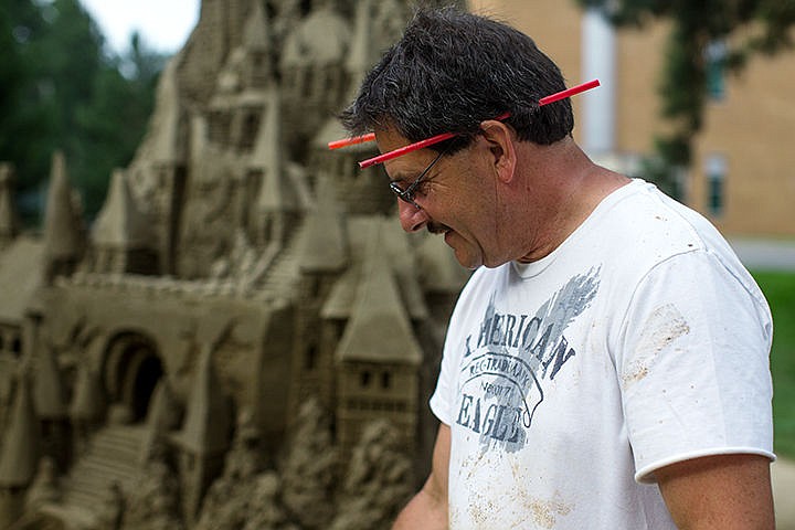 &lt;p&gt;TESS FREEMAN/Press&lt;/p&gt;&lt;p&gt;Scott Dodson cleans off the cement near his sandcastle at the 46th annual Art on the Green event. Dodson used 16 tons of sand for the sandcastle, which is expected to last 2 weeks after the event.&lt;/p&gt;
