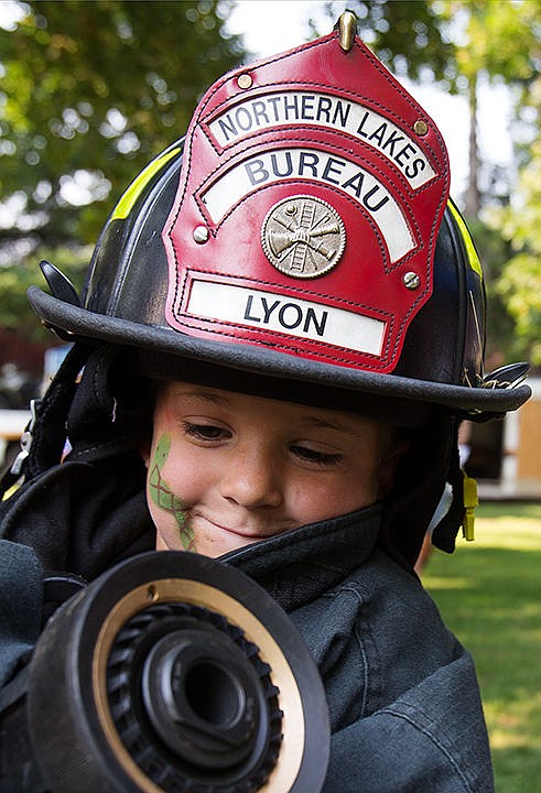 &lt;p&gt;TESS FREEMAN/Press&lt;/p&gt;&lt;p&gt;Jovanni Stanton, 4, tries on a Northern Lakes firefighter&#146;s gear at Kootenai County&#146;s National Night out Celebration in Hayden on Tuesday evening.&lt;/p&gt;