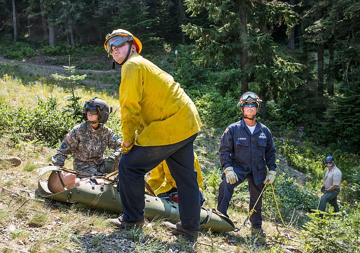 &lt;p&gt;JAKE PARRISH/Press&lt;/p&gt;&lt;p&gt;From left to right, U.S. Army Specialist Samantha Young, Kootenai County Search and Rescue volunteer Matt Dill, Coeur d'Alene Fire Department Deputy Chief Jim Washko and Kootenai County Sheriff's Office Deputy Chris Fresh watch as a rescue helicopter approaches their evacuation site during a helicopter rescue training drill Tuesday at Fernan Saddle in the Coeur d'Alene National Forest. The training involved evacuating a &quot;patient&quot; from the ground via helicopter using a system of pulleys.&lt;/p&gt;