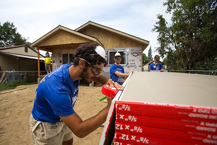 &lt;p&gt;TESS FREEMAN/Press&lt;/p&gt;&lt;p&gt;Alper Ender, 18, left,&#160;Andy Hollinger, 23, and Everett Secor, 22, cut drywall for a Habitat for Humanity house in Coeur d&#146;Alene on the tenth stop of their Bike and Build trip across America to raise awareness for affordable housing. The group started in Providence, R.I. on June 9, 2014 and stopped in ten cities to help build affordable houses before arriving in their final destination Seattle, Wash.&lt;/p&gt;