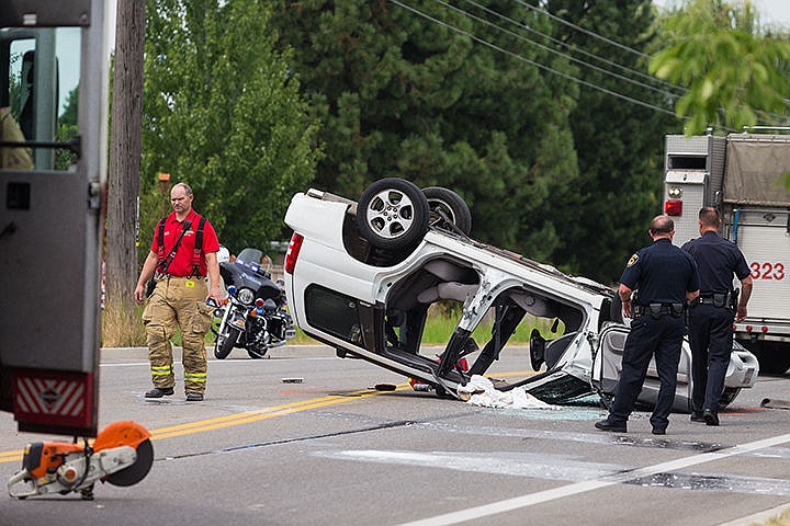 &lt;p&gt;SHAWN GUST/Press&lt;/p&gt;&lt;p&gt;Emergency personnel with the Coeur d&#146;Alene Fire Department and the Coeur d&#146;Alene Police Department work the scene of a vehicle that came to rest on it top after colliding with a parked SUV and rolling over Friday on 15th Street north of Margaret Avenue. Crews were working with the parties involved in a two-car accident at the nearby intersection when the female driver of the white SUV collided with a vehicle parked on the shoulder of 15th Street, causing her to rollover. After extraction, the driver was transported to Kootenai Health with minor injuries.&lt;/p&gt;
