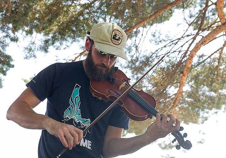 &lt;p&gt;MIKE CURRY/Press&lt;/p&gt;&lt;p&gt;Connor Wade, member of the band Sheepbridge Jumpers, plays his violin while practicing during a break in their tour Monday in the Coeur d&#146;Alene City Park.&lt;/p&gt;