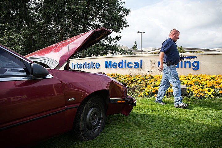 &lt;p&gt;TESS FREEMAN/Press&lt;/p&gt;&lt;p&gt;Chris Weitzel, with Parkwood Business Properties, picks up pieces of the Interlake Medical Building Sign after a driver ran into it on Friday morning.&lt;/p&gt;