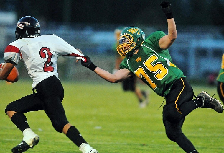 Browning's Kurt Redcrow attempts to escape the reach of Whitefish's Dakota Beatty.