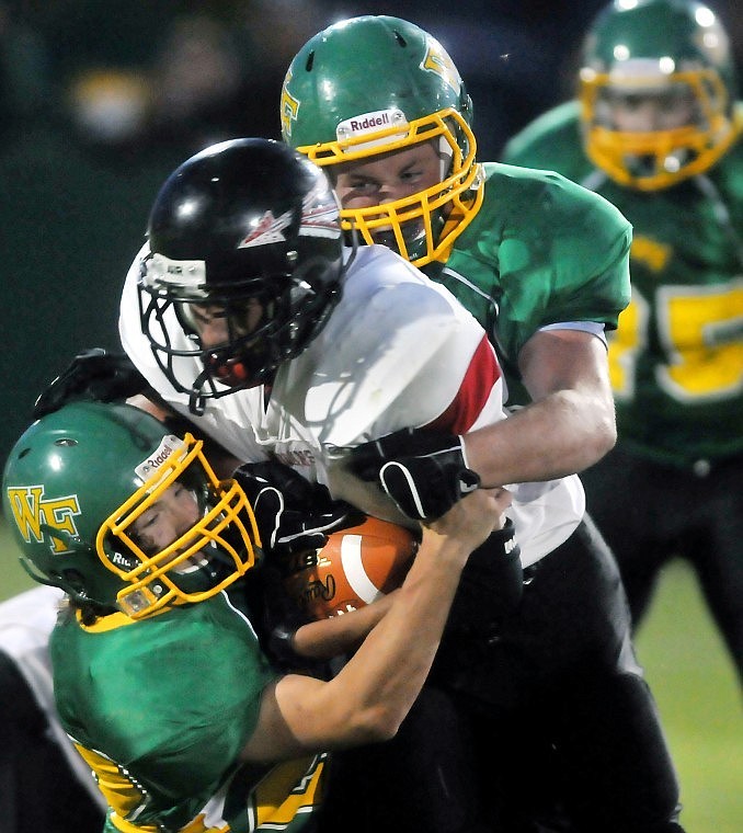 Whitefish's Jake May (top) and Mark Stephenson bring down Brownings' Brendon Runningwolf.