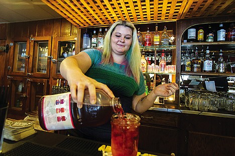 &lt;p&gt;Owner Karenna Mathis pours a drink for a customer Thursday at BlackJack Lil's restaurant and bar in Hauser Lake. The restaurant was opened earlier this month in a building thought to have been built around 1905 and has a rich history, serving as a brothel during the prohibition era and even featured a musical performance by Johnny Cash.&lt;/p&gt;