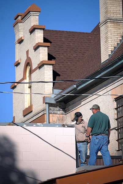 <p>Maintenance workers repair the roof of the Flathead County Juvenile Detention Center Thursday morning in Kalispell. According to the Flathead County Sheriffs Office, James Coby Smith, 12, pried open a small area of metal in the roof of the outdoor recreation area and crawled out Wednesday evening. Smith is back in custody.</p><p></p>