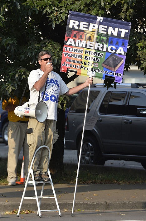 &lt;p&gt;A protester reads bible scripture to the protesters gathered at the Carl D. Perkins Federal Building in Ashland, Ky., Thursday.&lt;/p&gt;