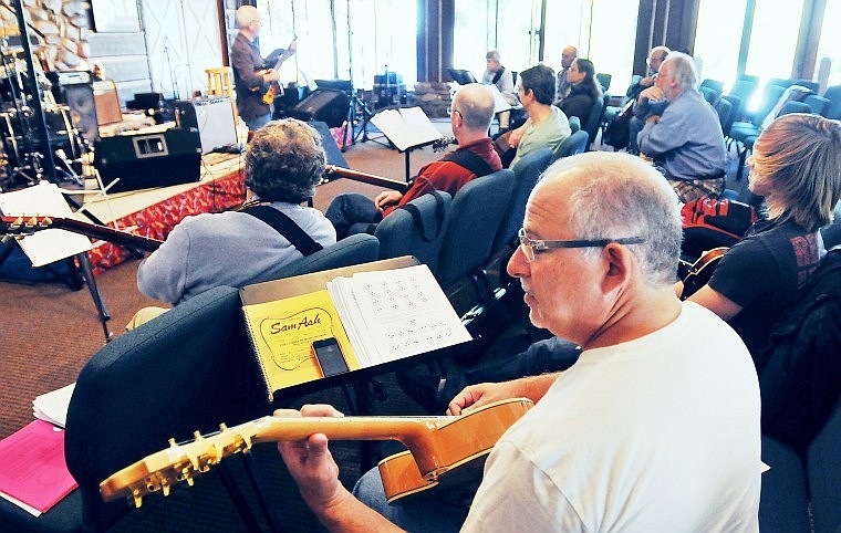 Alan Schulman of New York City strums his guitar while listening to Jody Fisher lead a workshop on jazz guitar Thursday morning at Flathead Lake Lodge in Bigfork during the Crown of the Continent Guitar Workshop.