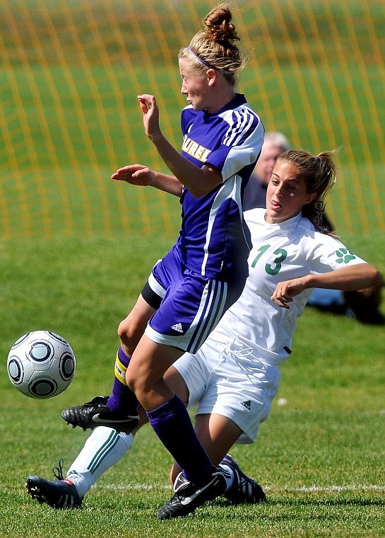 Whitefish's Presley Pritchard gets a kick around Laurel's Katie Day during Saturday afternoon's game in Whitefish. Pritchard scored the game's first goal in the third minute.