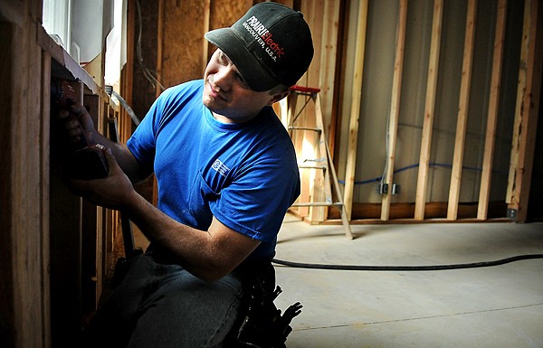 Jerome Carlson of Kalispell works on wiring the new classroom for electricity on Monday at Creston School. Carlson works for Simco Electric.