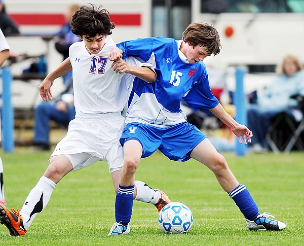 Columbia Falls freshman Chase Ramberg (17) battles with Bigfork sophomore Matt Killian (15) for possession of the ball during Tuesday&#146;s match in Columbia Falls.