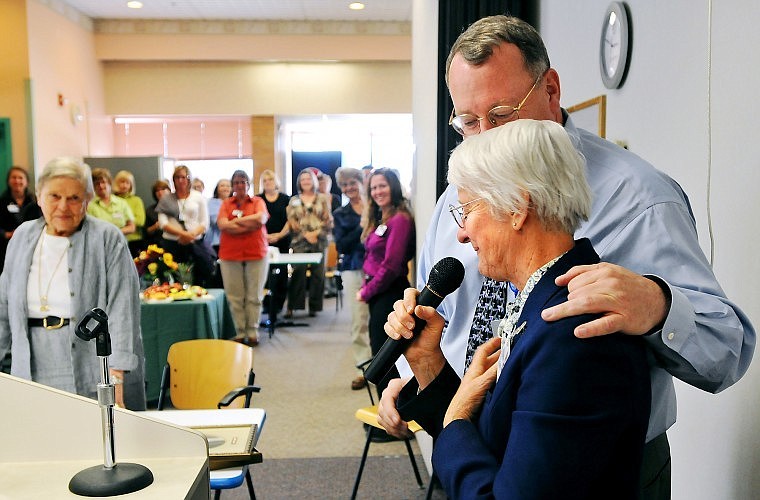 Sister Roxanne Dolak pauses before thanking an audience of Kalispell Regional Medical Center staffers while Chief Medical Officer Craig Eddy puts his arm around her Wednesday during a celebration of 100 years of the Sisters of Mercy providing hospital care in Kalispell.