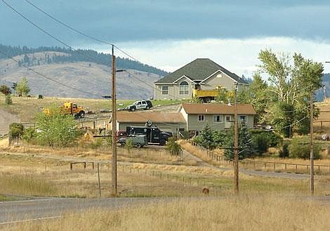 Armored vehicles in front of the house during the final assault that brought the standoff to an end.