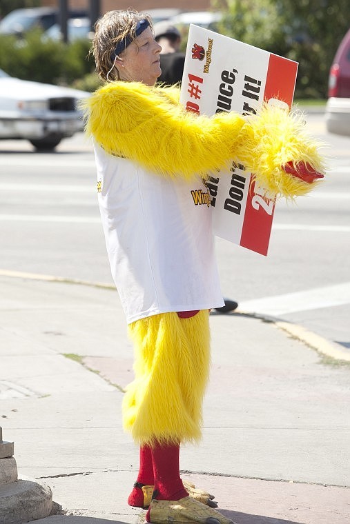 &lt;p&gt;Brenda Herbst, dressed as Cluck the Pizza Hut chicken, takes a
break from waving a promotional sign at passing cars on the corner
of Idaho and Main streets.&lt;/p&gt;