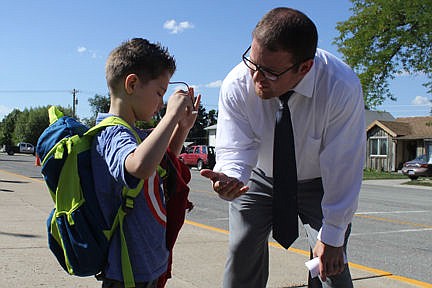 &lt;p&gt;Jacob, 6, gets ready to board the bus as new Principal Brent Benkelman gives him a low-five.&lt;/p&gt;