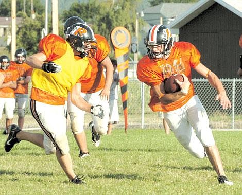 Fullback Tyson Noyes gets free and sprints for a 25-yard gain; Quarterback Mike Fisher looks on from the backfield.