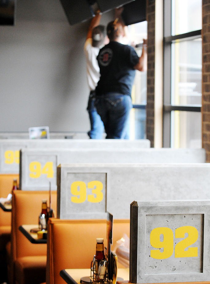 <p>The Buffalo Wild Wing booths are numbered like stadium sections as part of the overall design. (Aaric Bryan/Daily Inter Lake)</p>