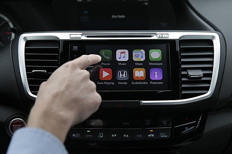 &lt;p&gt;Chris Martin from Honda North America demonstrates Apple CarPlay in Torrance, Calif., on Aug. 20.&lt;/p&gt;