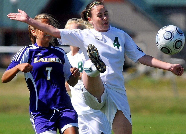 Whitefish's Charlotte Kamarath swings her leg up in the air to connect with the ball.