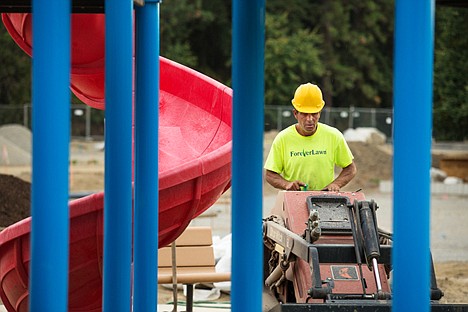 &lt;p&gt;Jess Freeman with Forever Lawn levels some gravel Wednesday at the new play structure in McEuen Park. The company is putting in foam pads and hi-tech grass infused with shredded recycled rubber to add around 11 feet of fall protection around the entire structure.&lt;/p&gt;