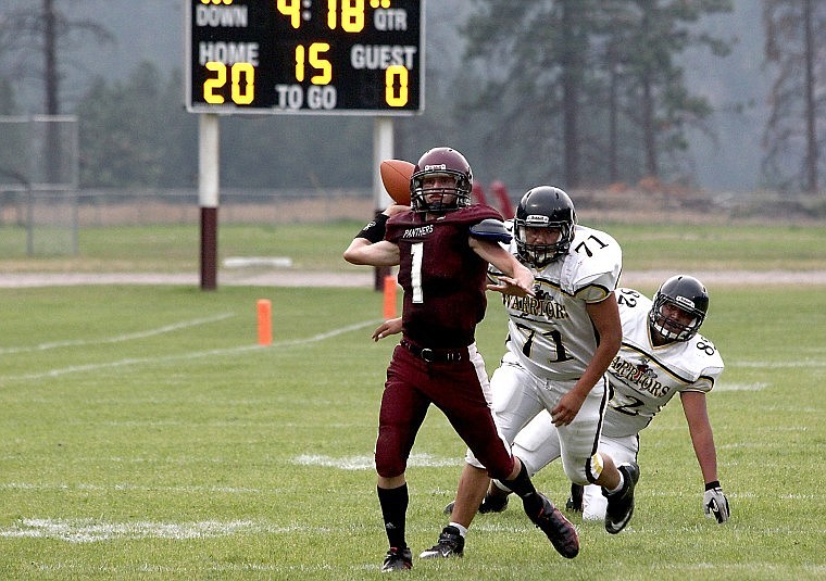 &lt;p&gt;Alberton sophomore quarterback Jack Lehl uses his speed and strength to extend a broken play and attempt a pass during Friday's game against the Heart Butte Warriors.&lt;/p&gt;