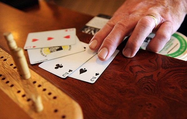 Brenda Ahearn/Daily Inter Lake
Keith Bassett, co-creator of TurboCrib shows how a hand in their game can utilize the Joker, a card not used in traditional cribbage.