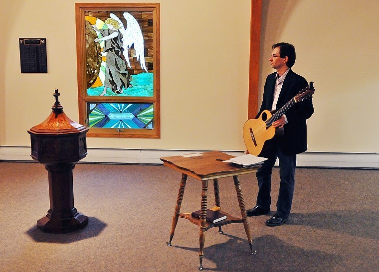 Andrew Leonard, a master of classical guitar, waits in the back of the church to perform duets with Doug Smith, another internationally known guitarist.