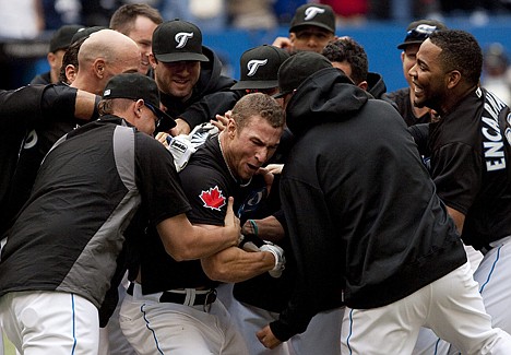 &lt;p&gt;Toronto's Brett Lawrie is mobbed by teammates after hitting a walk-off home run for the Blue Jays' 1-0 win over Boston on Monday in Toronto.&lt;/p&gt;