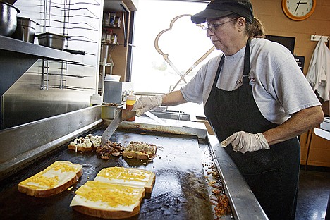 &lt;p&gt;Veanne Fogg watches over the grill as customers' sandwiches are prepared Wednesday at Meltz in Coeur d'Alene.&lt;/p&gt;