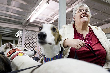 &lt;p&gt;Donna Beckman of Post Falls laughs as her greyhound Lindy, center, checks out what is going on Saturday at the 11th Annual Greyhound Picnic at the Kootenai County Fairgrounds.&lt;/p&gt;