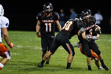 &lt;p&gt;Post Falls Trojan, Michael Mckeown, powers up the field while being grappled by a Graham Kapowsin Eagles player in the 3rd quarter of Thursday's game at Post Falls High School.&lt;/p&gt;