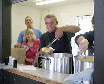 &lt;p&gt;Dennis Watson serving grilled and boiled corn at the inaugural corn feed. (Bethany Rolfson/The Western News)&lt;/p&gt;