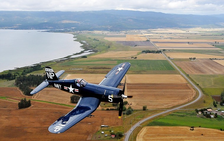 A Corsair plane piloted by Steve Bakke flies over Montana Highway 82.