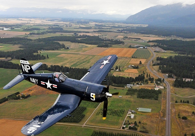 A Corsair plane piloted by Steve Bakke flies over Montana Highway 35.