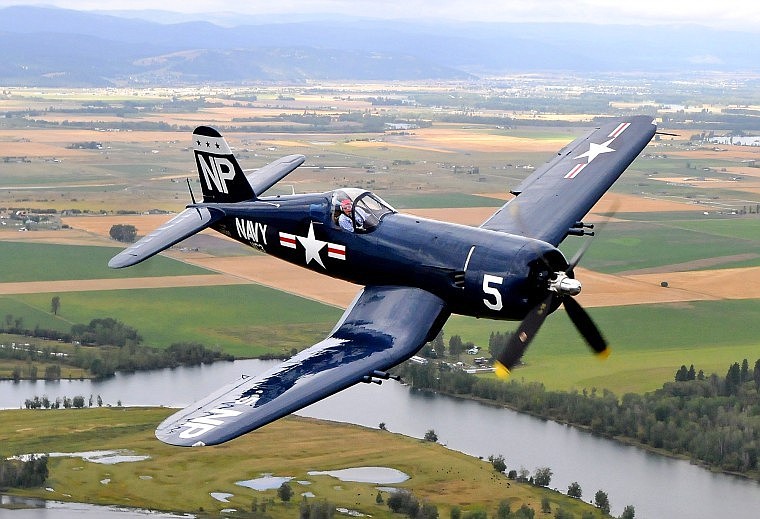 A Corsair plane piloted by Steve Bakke flies over a portion of the Flathead Valley.